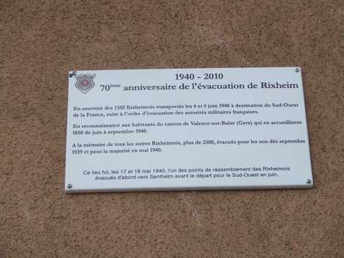 Sur la façade du bâtiment, cette plaque rappelle l'évacuation de Rixheim, les 17 et 18 mai 1940, évacuation qui est à l'origine du jumelage entre Rixheim et le canton de Valence-sur-Baïse dans le Gers.
