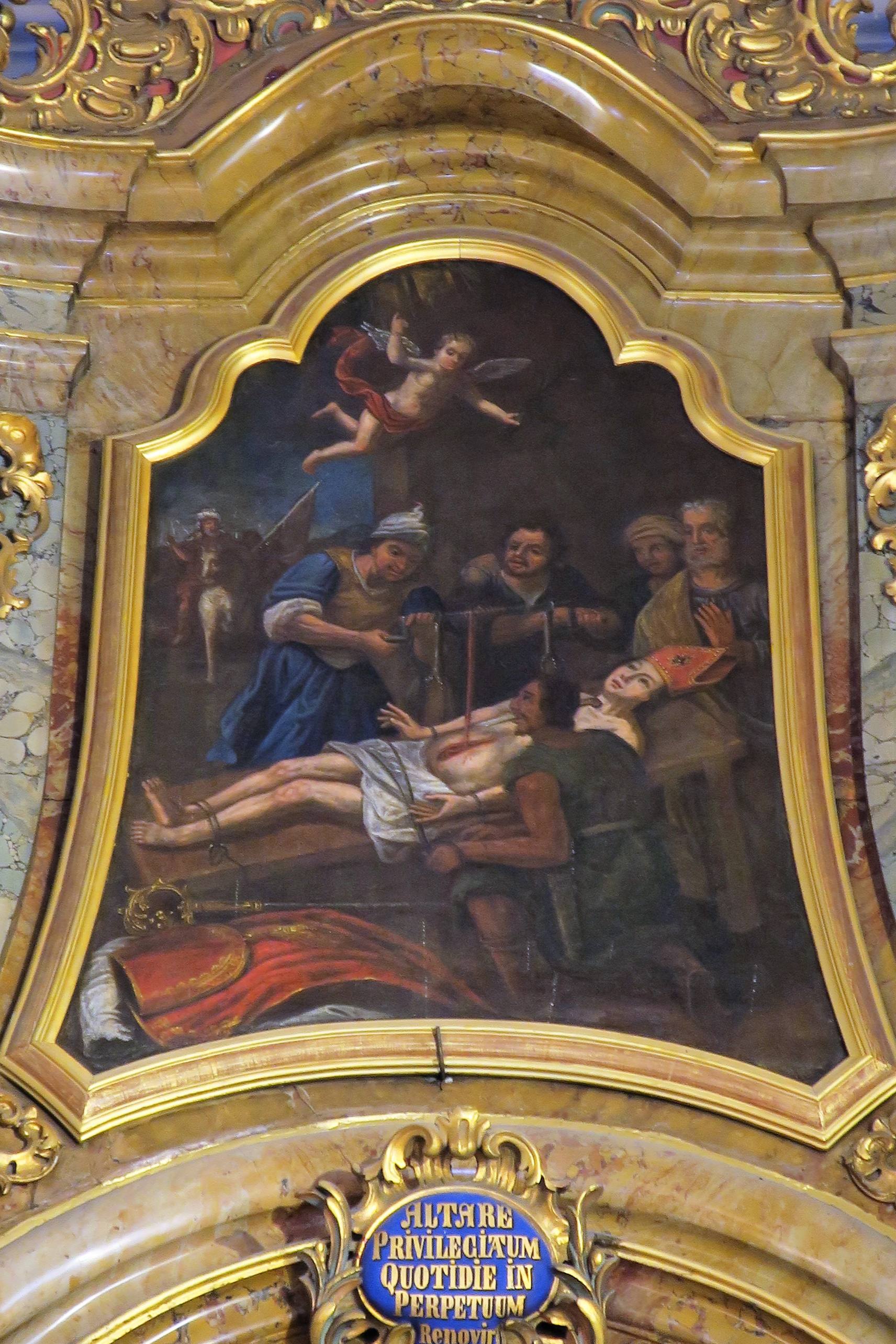 Le médaillon de l'autel latéral droit représente le martyre de Saint Erasme, dont les bourreaux retirent les viscères 